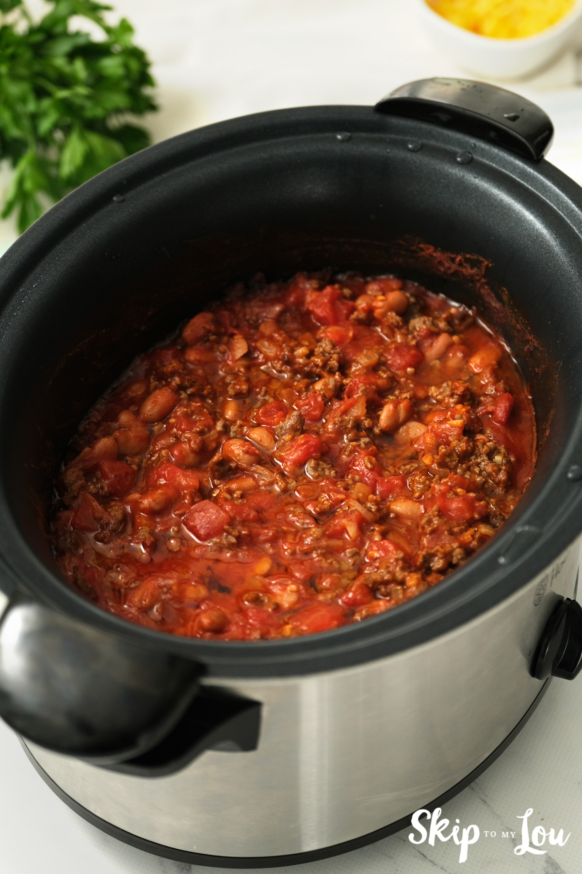 Crock pot with slow cooker chili inside, by Skip to my Lou.