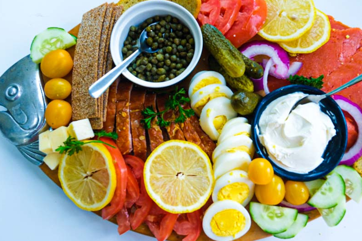 Hard-boiled eggs, fresh vegetables,  capers, smoked salmon, pickles, and crackers are included on Amazing Charcuterie Boards.