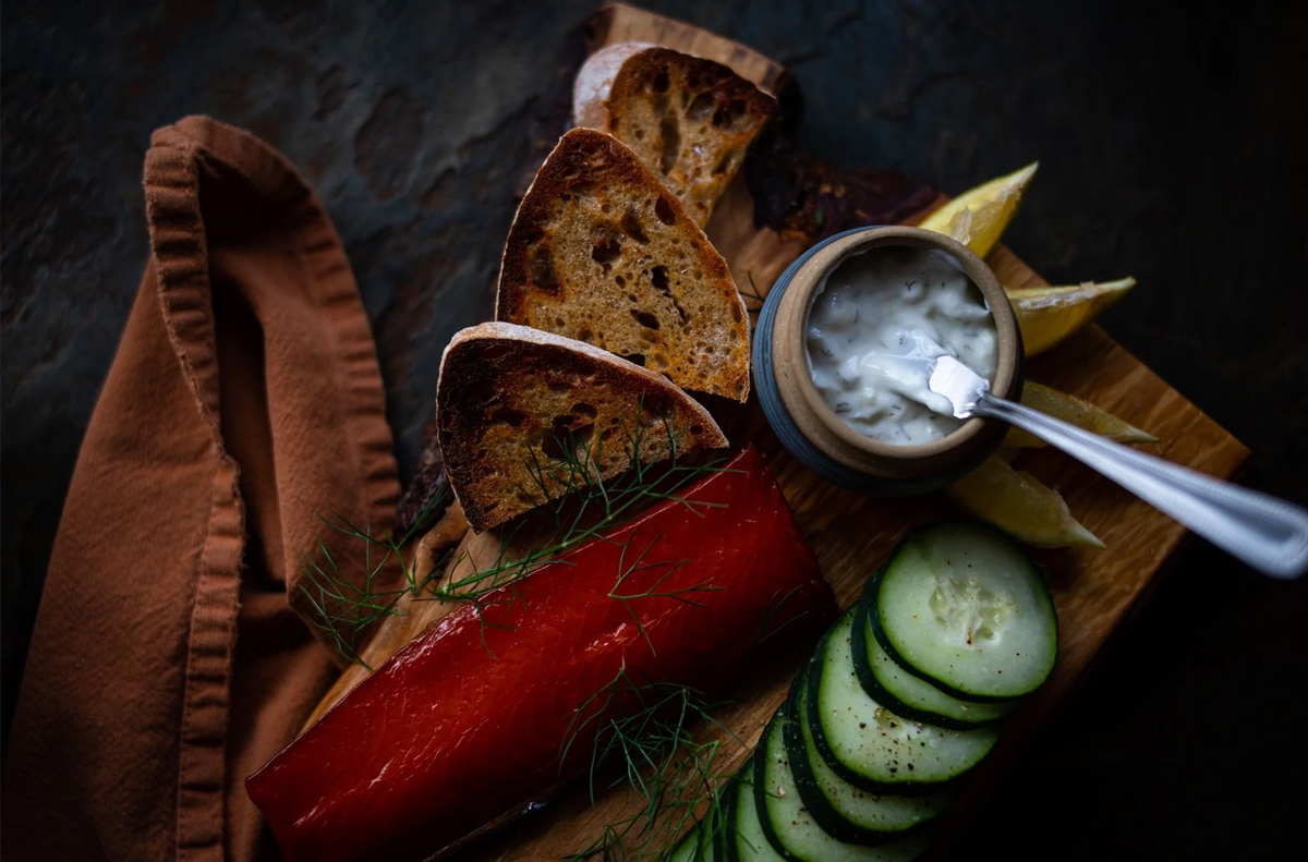Catch Sitka Seafoods board is filled with fresh veggies, sour cream dip, crackers, and salmon.