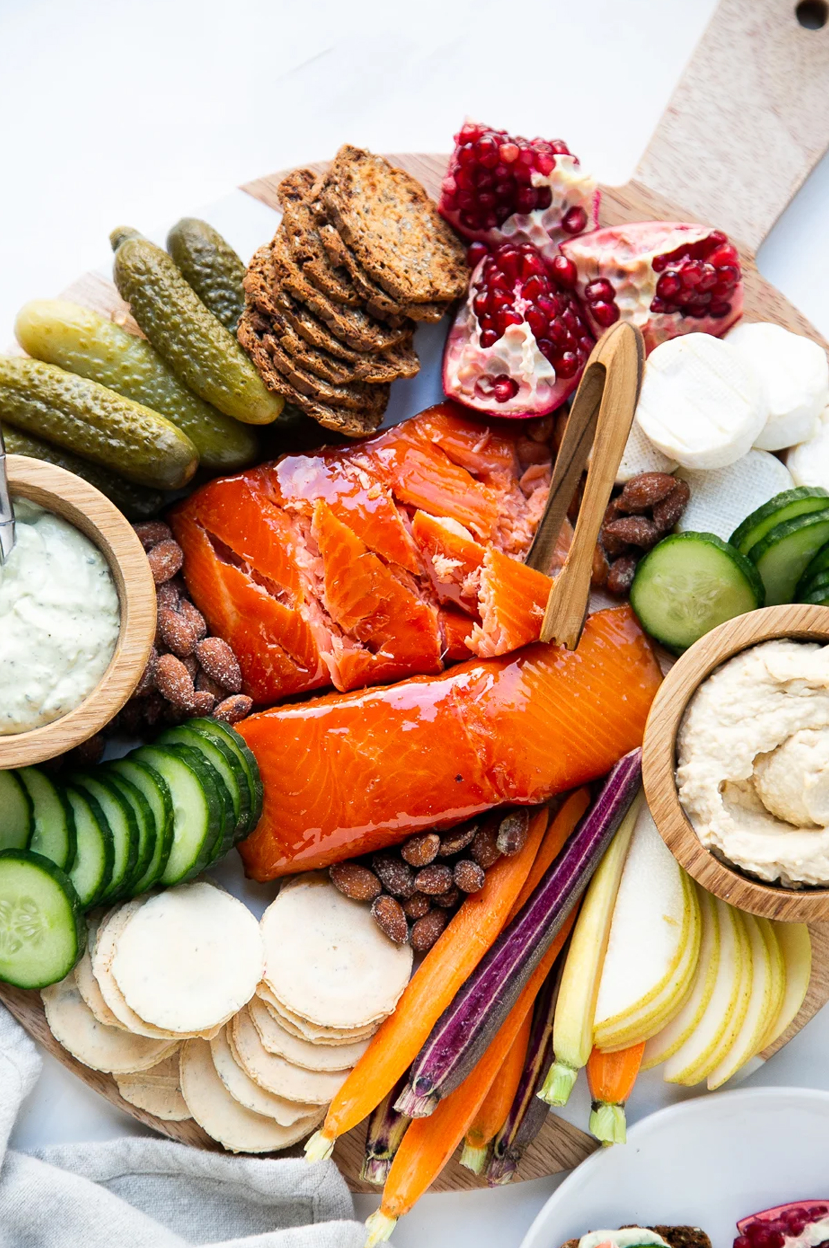 Perry's Plate salmon board showcases pomegranate, crackers, brie, and salmon.