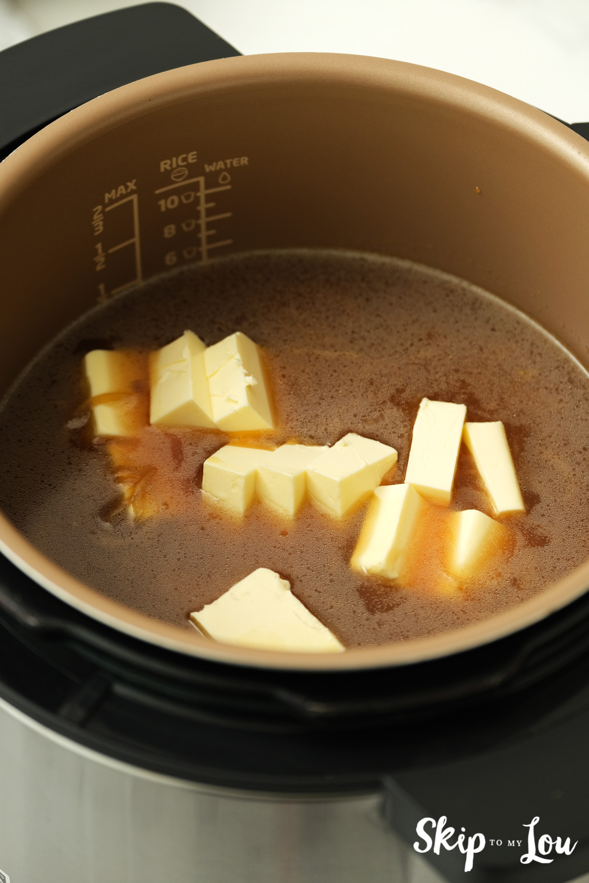 Pats of butter in beef broth for stick of butter rice, by Skip to my Lou.