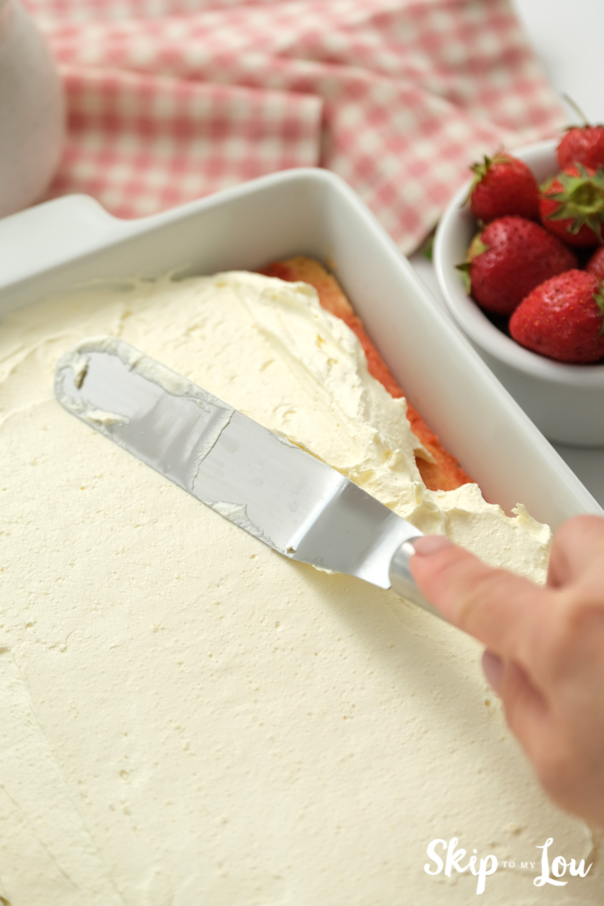 White icing smoothed out with an offset spatula, by Skip to my Lou.