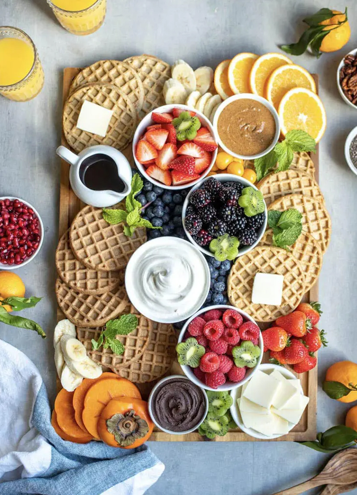 a simple waffle board from ain't too proud to meg includes a variety of fruit, whipped cream, and more.