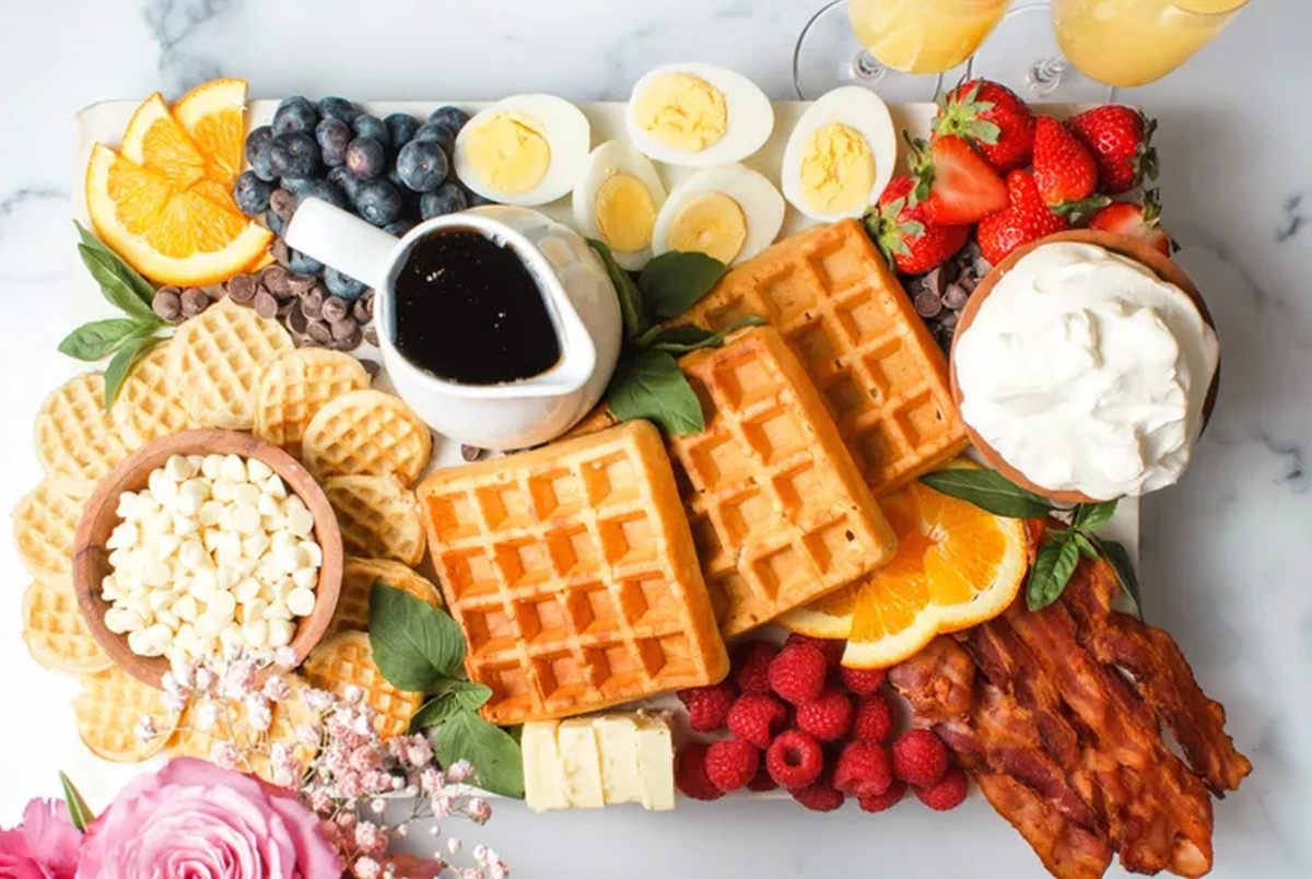 hard-boiled eggs, mini and large waffles and bacon fill this waffle charcuterie board recipe from all recipes.