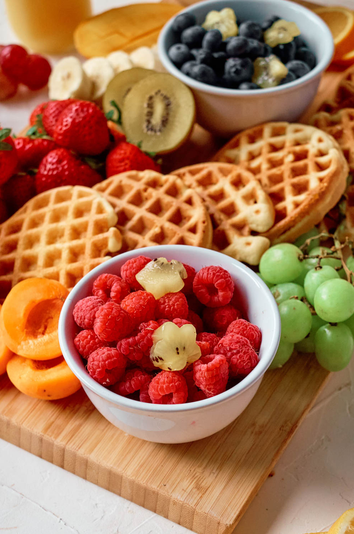 kiwi stars, mini waffles, and fresh fruit is all you need for this waffle board from busy being jennifer.