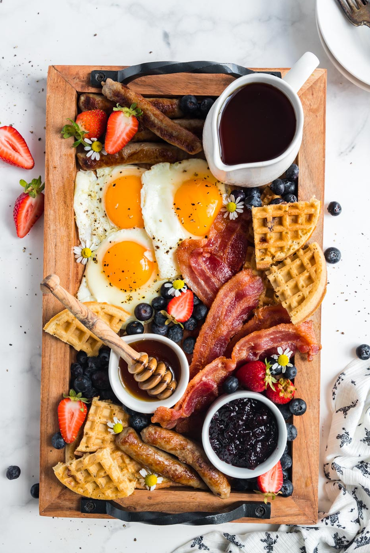 bacon, sausage, eggs and waffles make the perfect board from feast and farm.