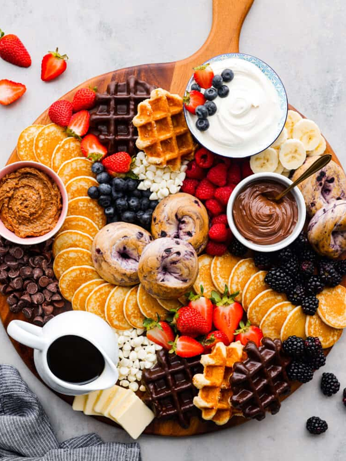 a mix of waffles, pancakes, and bagels along with plenty of toppings like fruit, whipped cream, and peanut butter from the recipe critic.