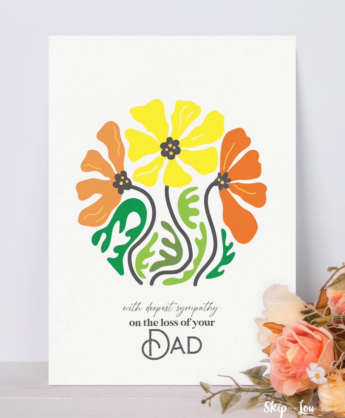 Printed dad sympathy card with flowers next to it.