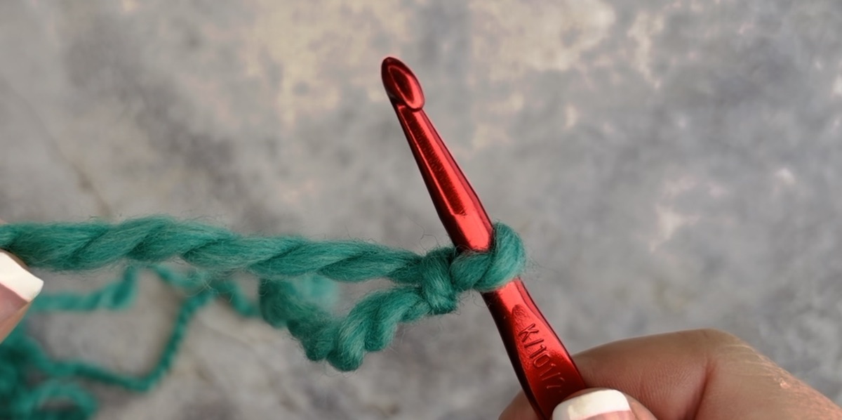 How to make a slip knot using a crochet hook, step 5, once your knot is as tight as needed, just take out the hook
