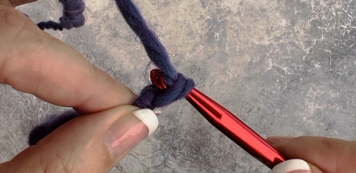 Second step to create a chain crochet - pull through the second hole