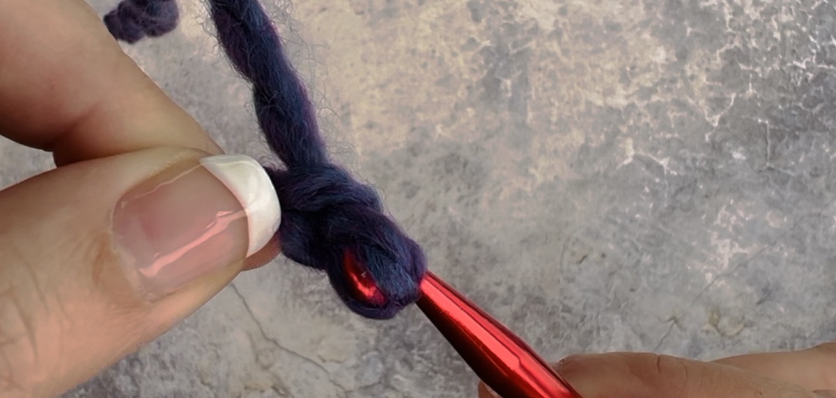 Fifth step to create a chain crochet - pull the hook all the way through the hole