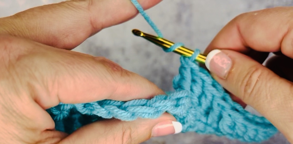 Step 1 to do a treble crochet: yarn over the hook