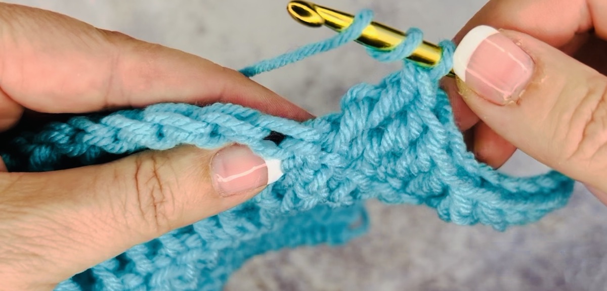 Step 1 part 2 to do a treble crochet: create three lops
