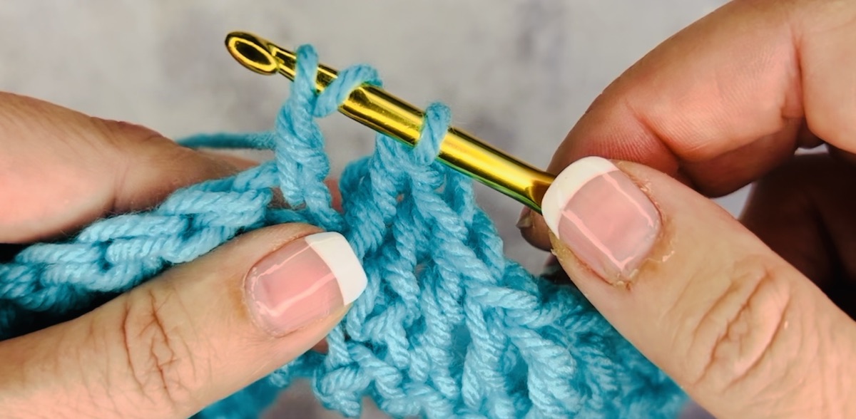 Step 4 to do a treble crochet: now you have three loops 