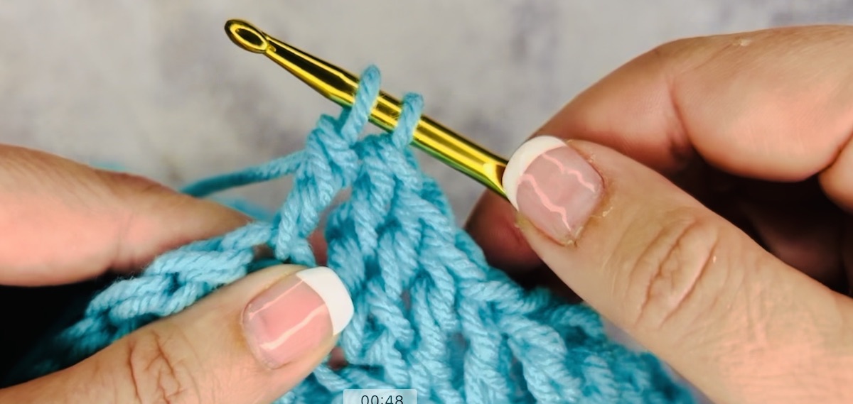 Step 5 to do a treble crochet: Now, you'll have two loops left on your hook.