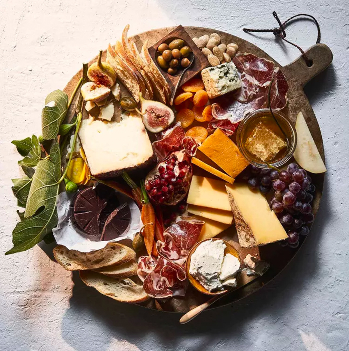 Dried fruit, figs, cheese, chocolate, meat, and nuts complete Eating Well's recipe's winter charcuterie board.