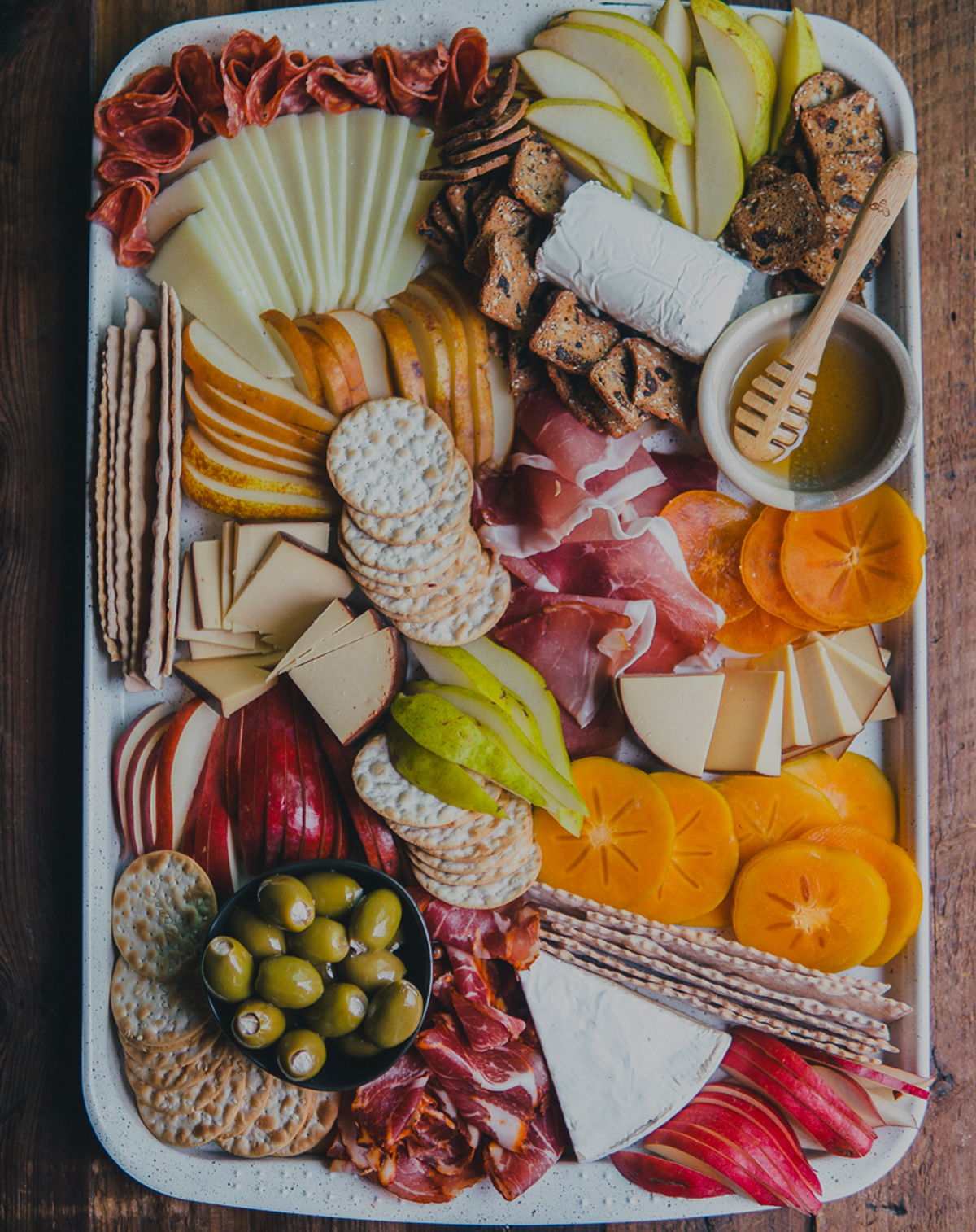 Feeding the Frasers winter spread includes seasonal fruit, cheese, meats, and crackers,