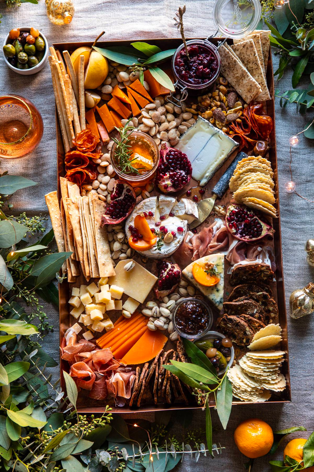 Half Baked Harvest's Cheese board includes nuts, crackers, meats, and cheeses.