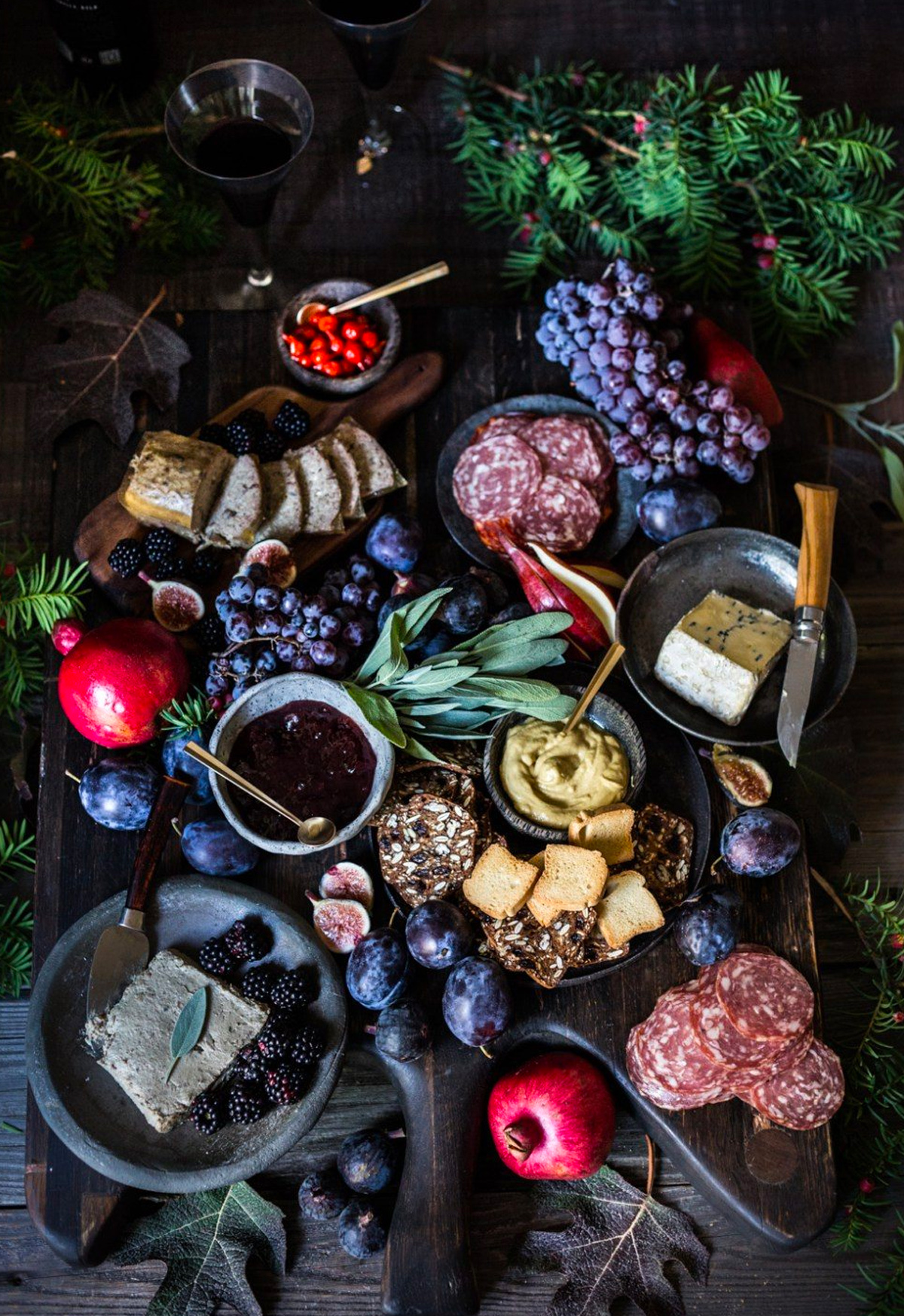 Grapes, meats, berries, pears, cheese, figs, and crackers fill Honest Cooking's winter board.