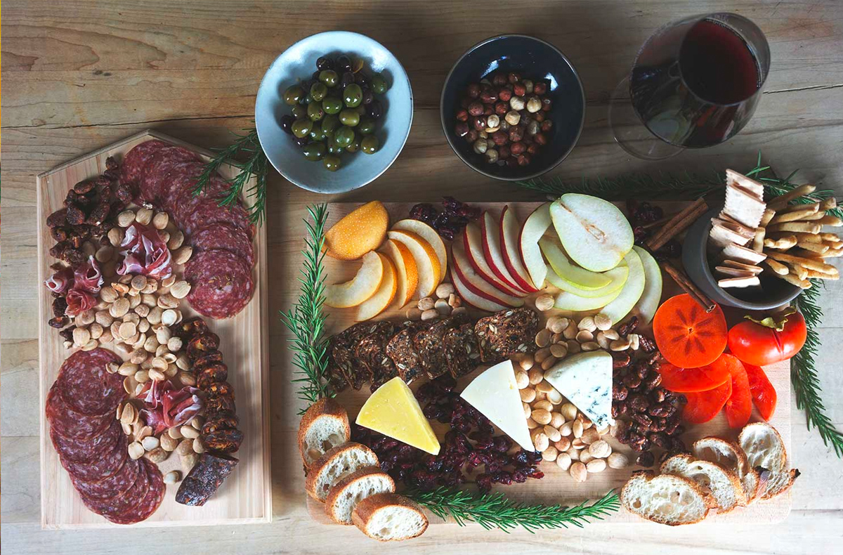 Meats, nuts, cheese, bread, crackers, and wine complete Kanpai Wine's Winter Charcuterie Board.