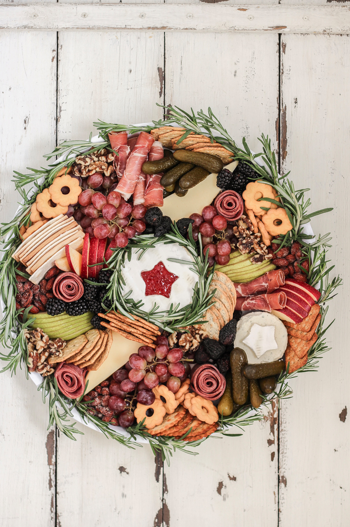 Meats, cheese, berries, pickles. grapes, and crackers fill Love Grow Wild's charcuterie board.