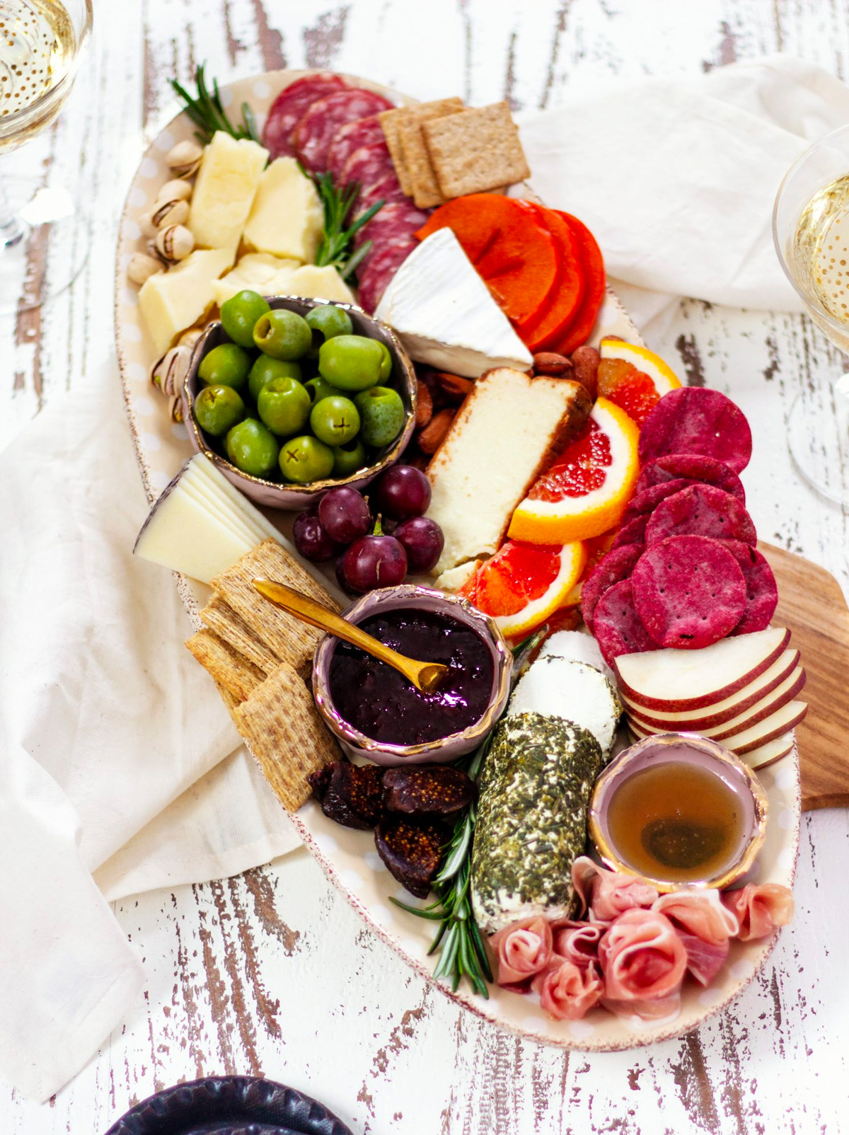 Crackers, cheese, nuts, grapes, and olives complete Parsnips and Pastries winter charcuterie board.