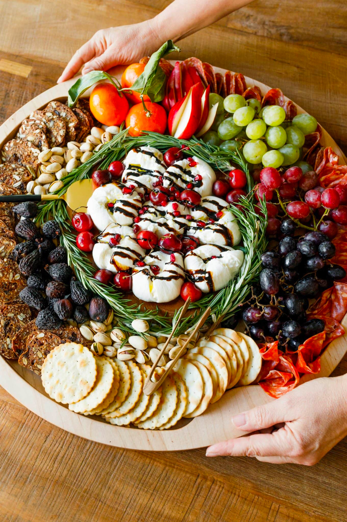 The Reluctant Entertainer's charcuterie board is complete with meats, cheese, dried fruit, crackers, and grapes.