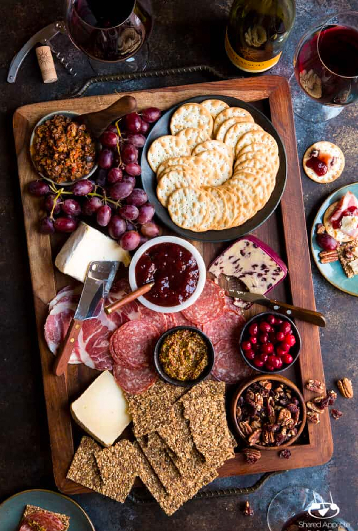 Shared Appetite's winter board includes cheese, crackers, grapes, and meat.