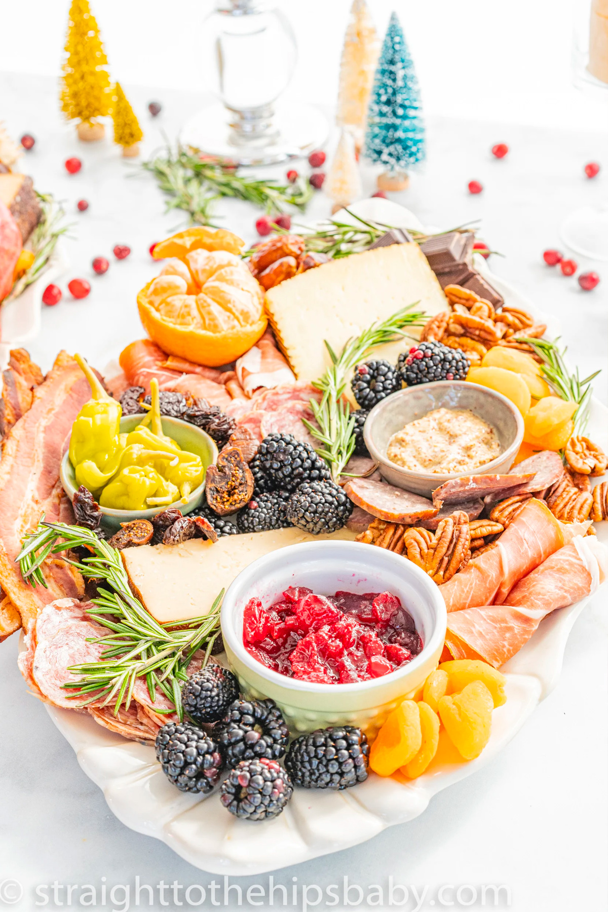 Straight to the Hips, Baby's winter charcuterie board is complete with berries, meat, cheese, seasonal fruit, and nuts.
