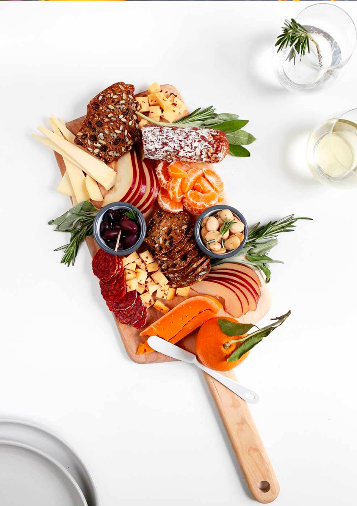 The Faux Martha's board is complete with clementine's, cheese, meat, crackers, and olives.
