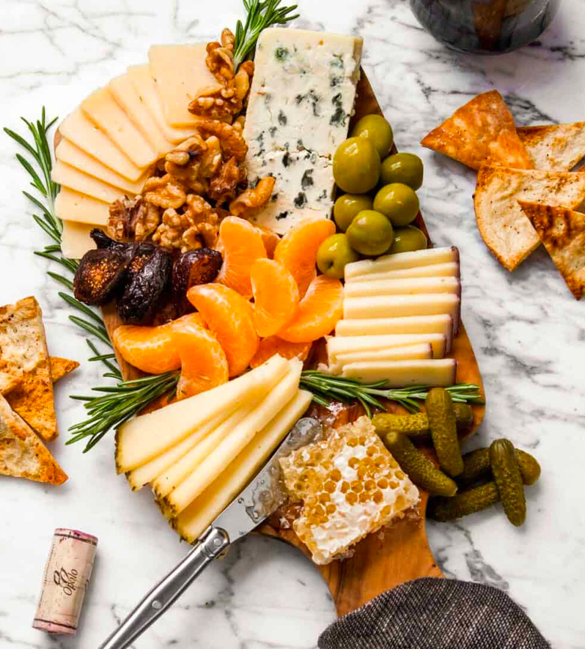 Cheese, olives, clementine's nuts, and crackers complete Zestful Kitchen's winter cheese board.