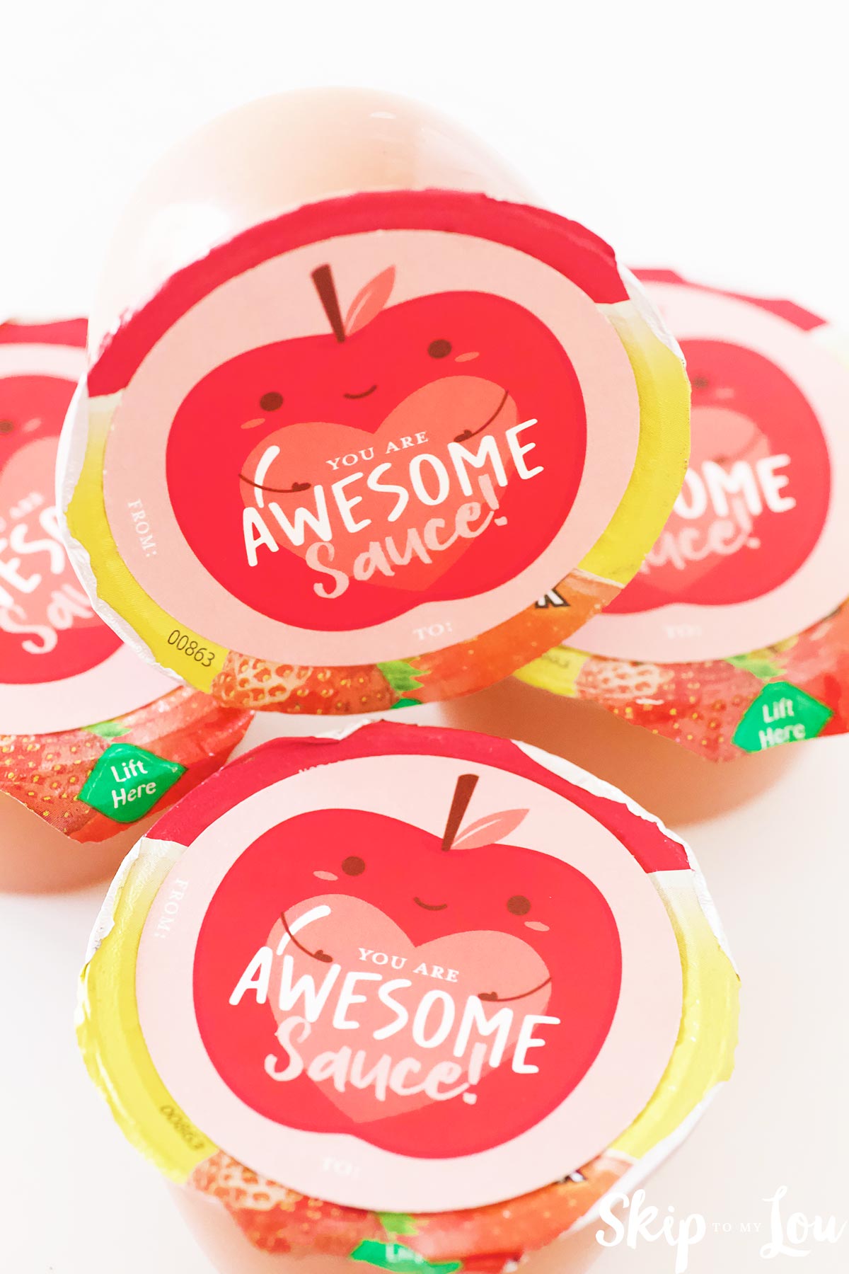 individual apple sauce cups stacked up and they have a free printable on top that says you're awesomesauce