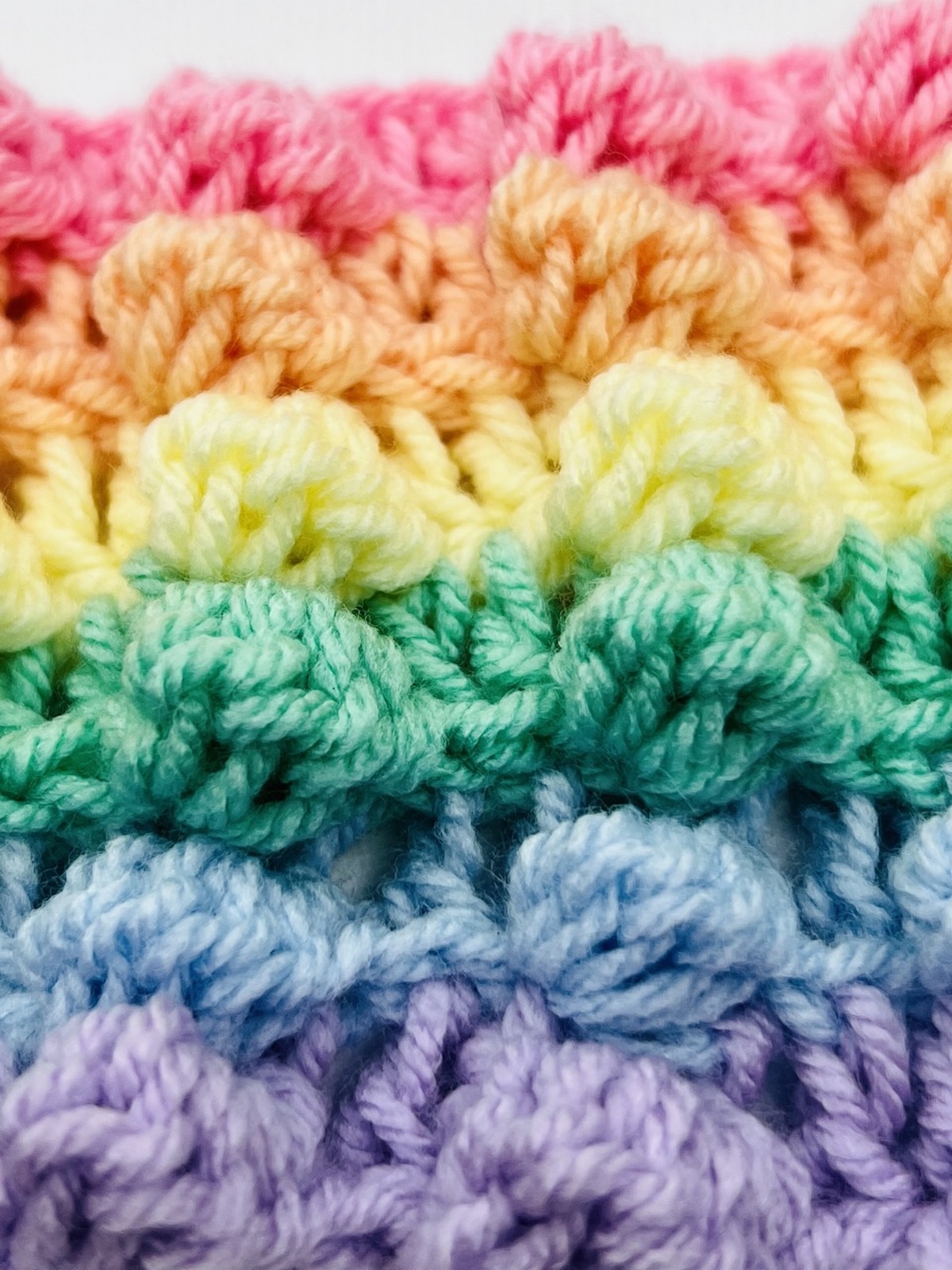 Finished multicolored bobble stitch pattern in pink, orange, yellow, green, blue, and purple.
