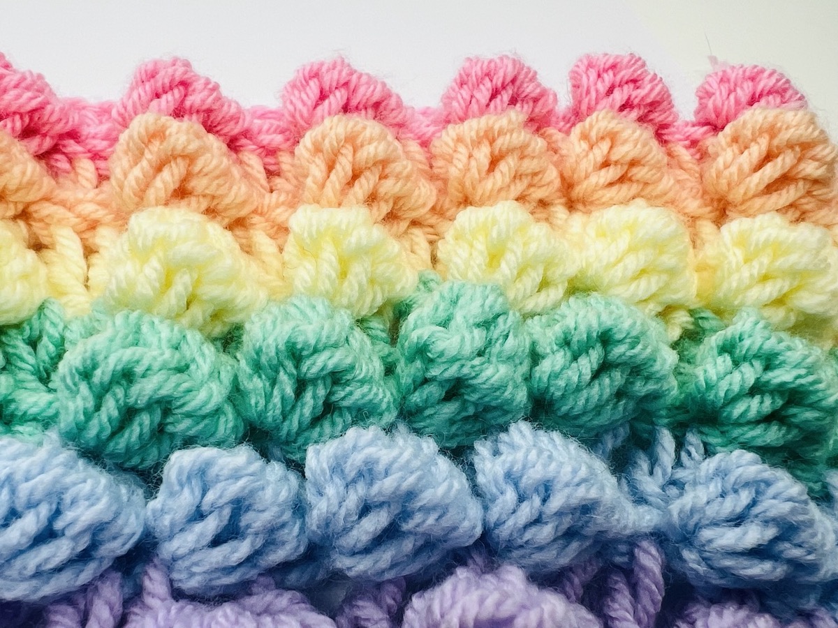 Finished multicolored bobble stitch pattern in pink, orange, yellow, green, blue, and purple.
