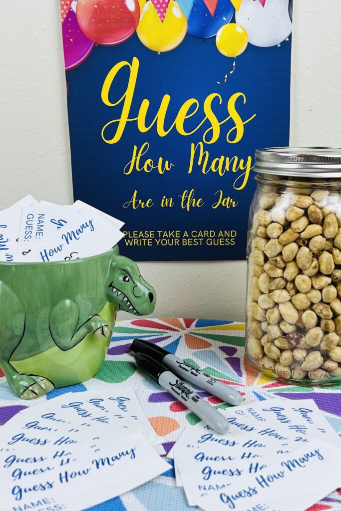 guess how many in the jar sign with a mason jar of peanuts, pens and cards for making guesses