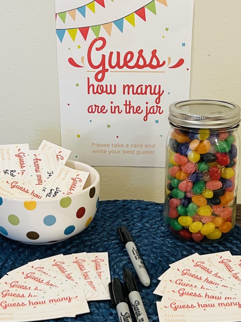 guess how many in the jar sign with a mason jar of jelly beans, pens and cards for making guesses