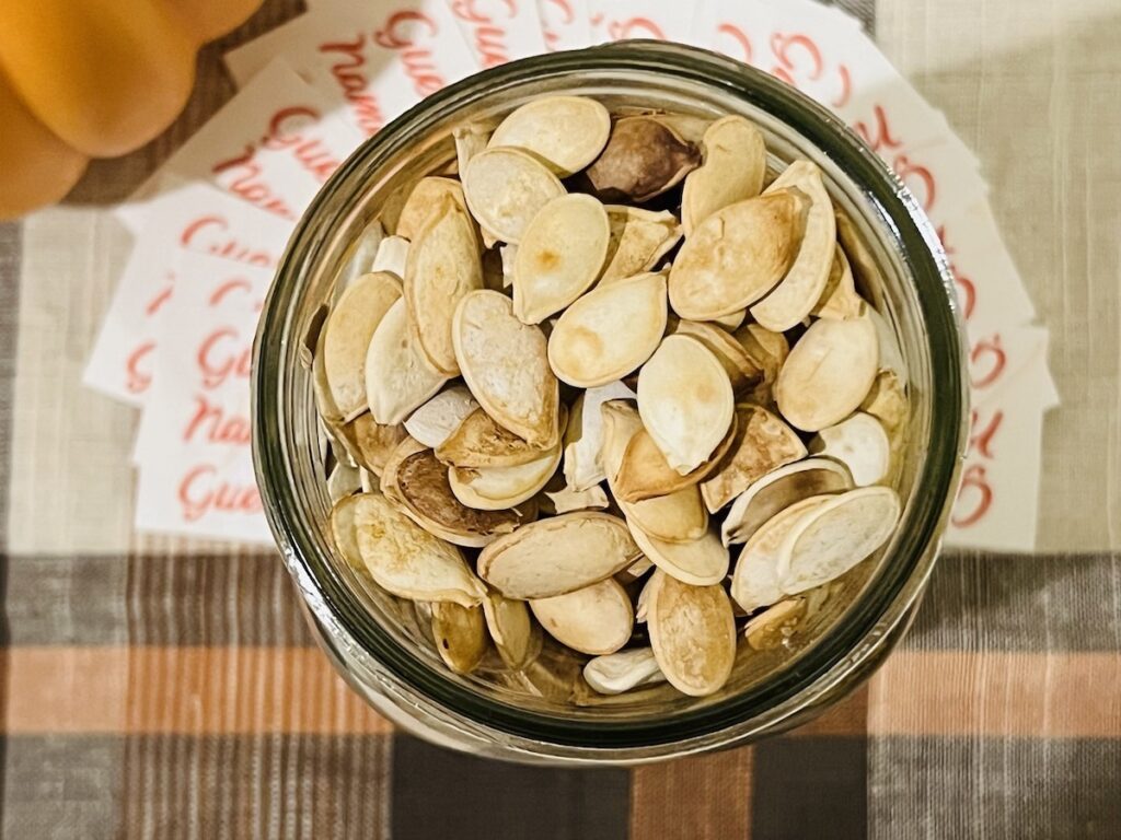 top view pumpkin seeds in a mason jar for the guess how many game