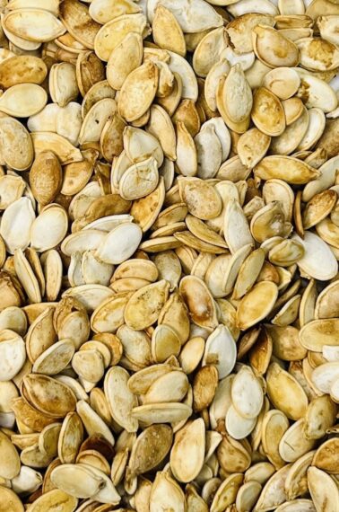 closeup of a big pile of pumpkin seeds for the guess how many in the mason jar game