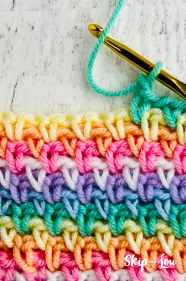 Linen stitch crochet swatch in assorted colors of yellow, pink,white, purple, blue, and green.