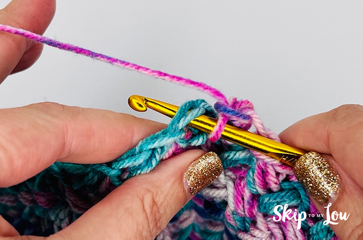 Crochet sample of the mini bean stitch in varying shades of pinking blue.