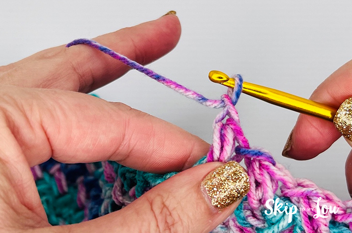 Crochet sample of the mini bean stitch in varying shades of pinking blue.