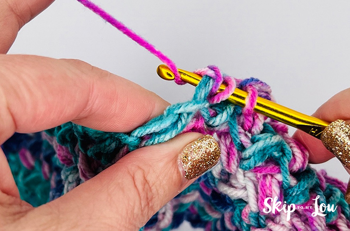 Crochet sample of the mini bean stitch in varying shades of pink and blue.
