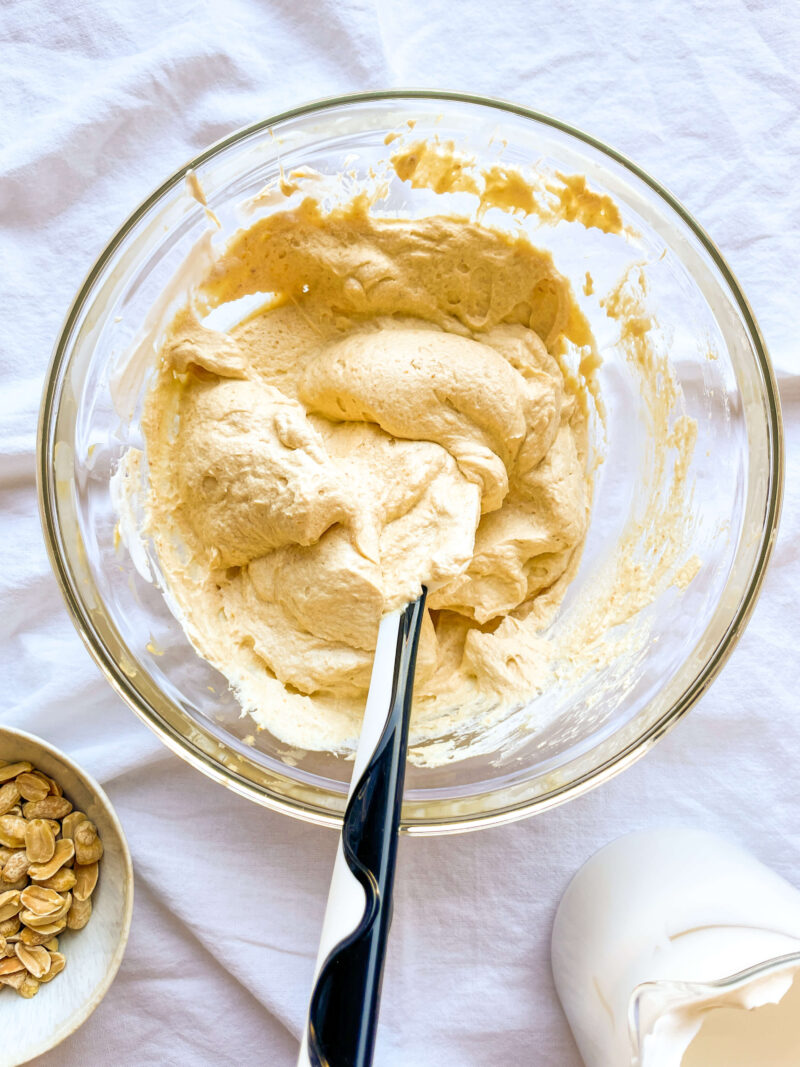 Image shows the heavy whipping cream, one tablespoon honey, and teaspoon vanilla mixed together in a bowl.