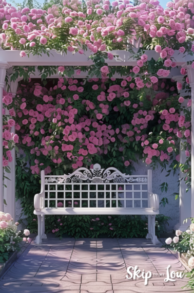 white bench under a trellis in a pink rose garden filled with pink rose blooms