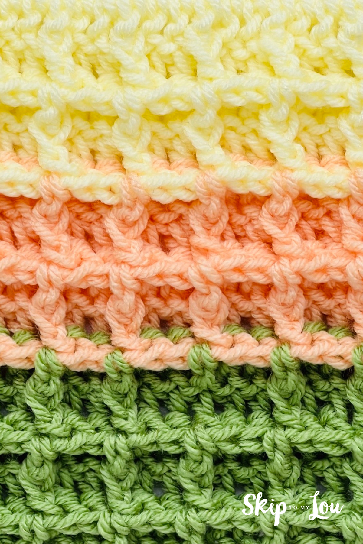 Waffle stitch crochet pattern in light yellow, orange, and green.