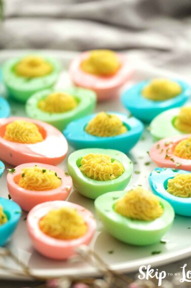 colored easter deviled eggs on a platter
