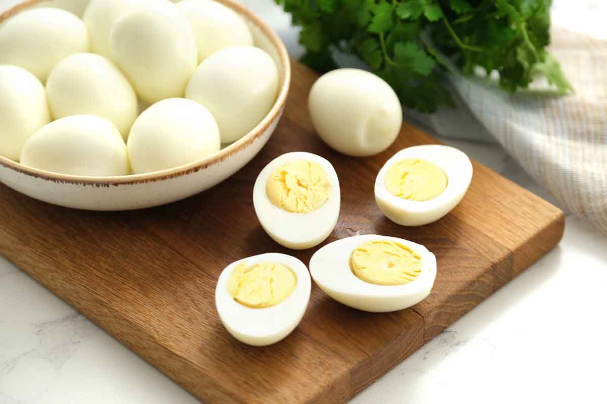 sliced hard boiled eggs on a cutting board