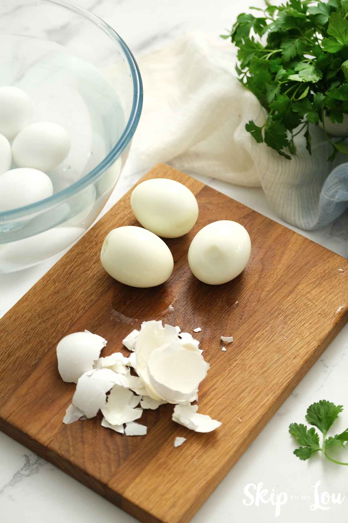 peeled boiled eggs on cutting board