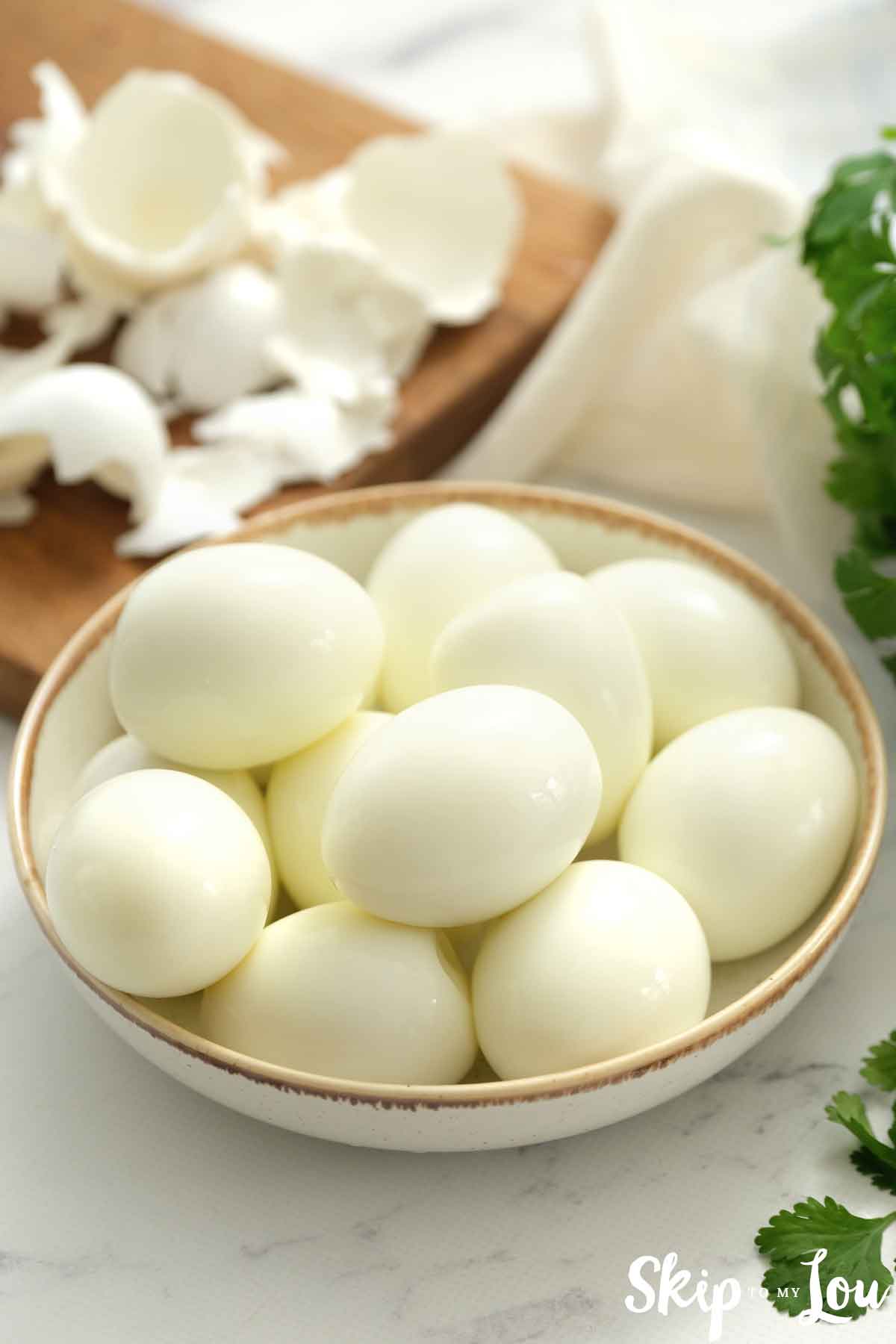 peeled hard boiled eggs in a bowl