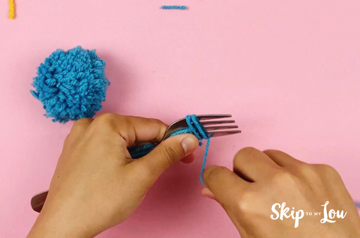 Wrapping the wool around a fork which is now turned sideways.